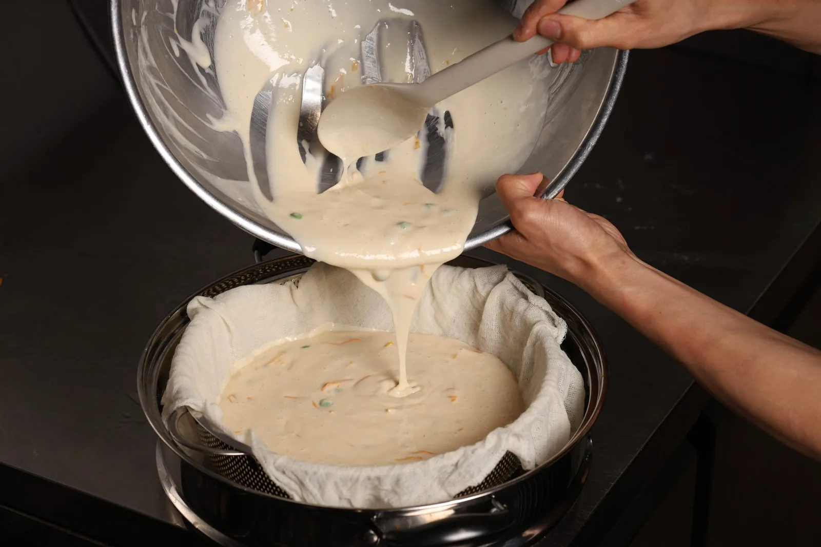 Batter poured into a cloth-lined steamer