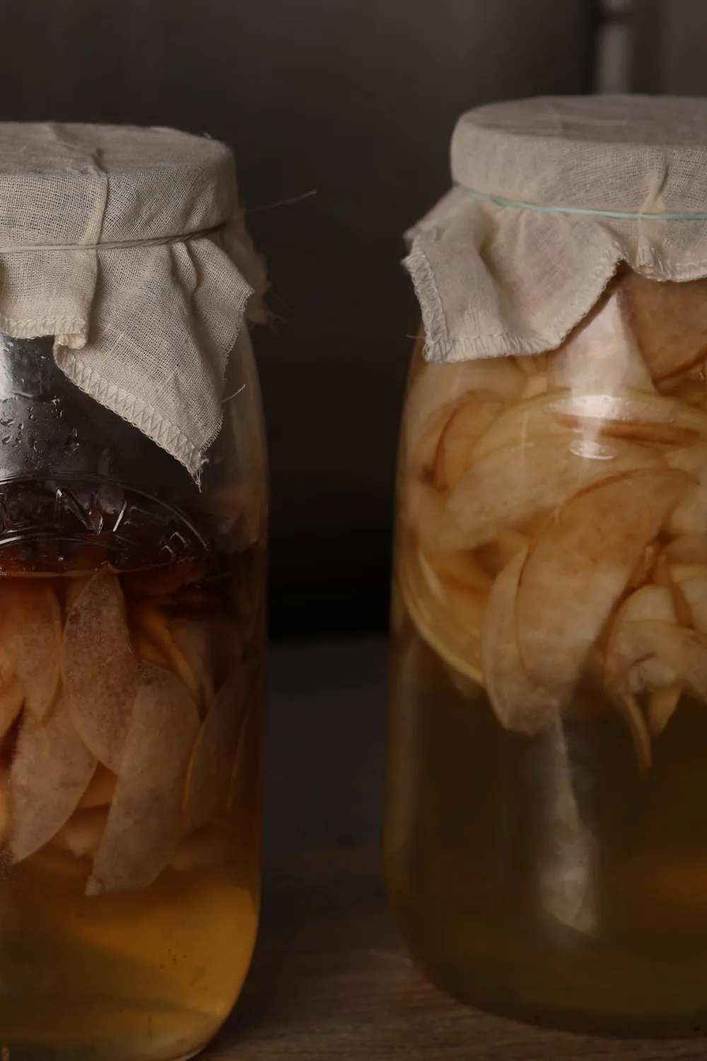 Jars of fruit cheong, cloth tied over the top