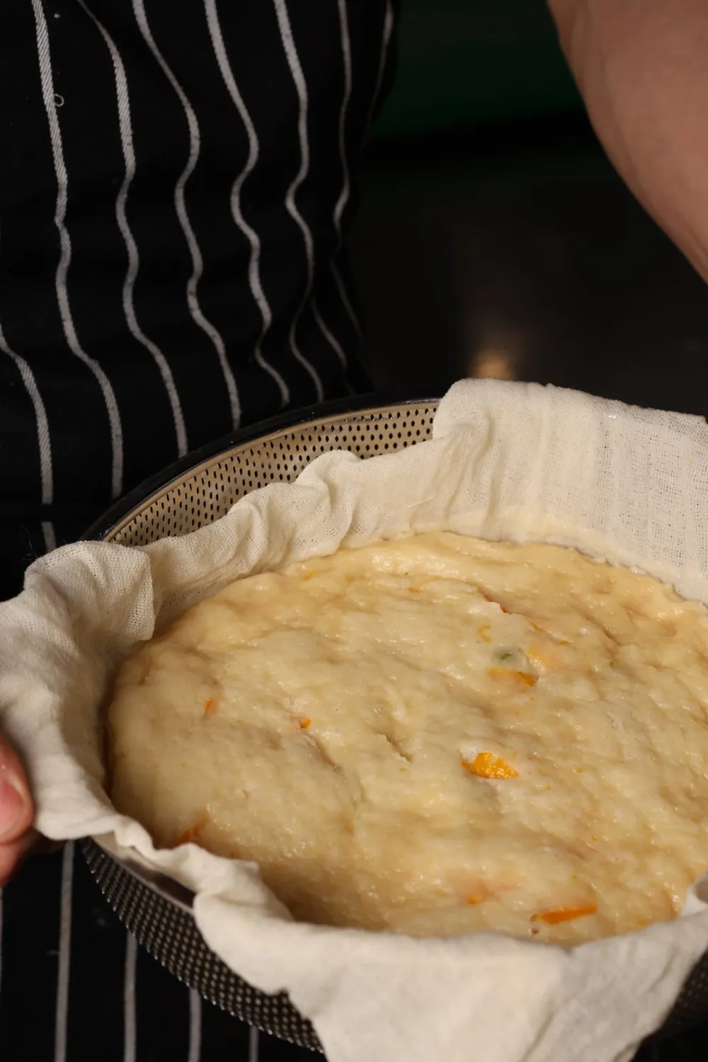 Makgeolli bread batter lifted in a cloth-lined steamer basket