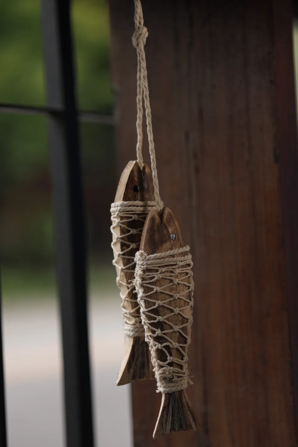 Two wooden fish hanging by the door